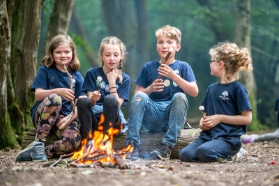 Children toasting marshmallows around a fire at Great Walstead